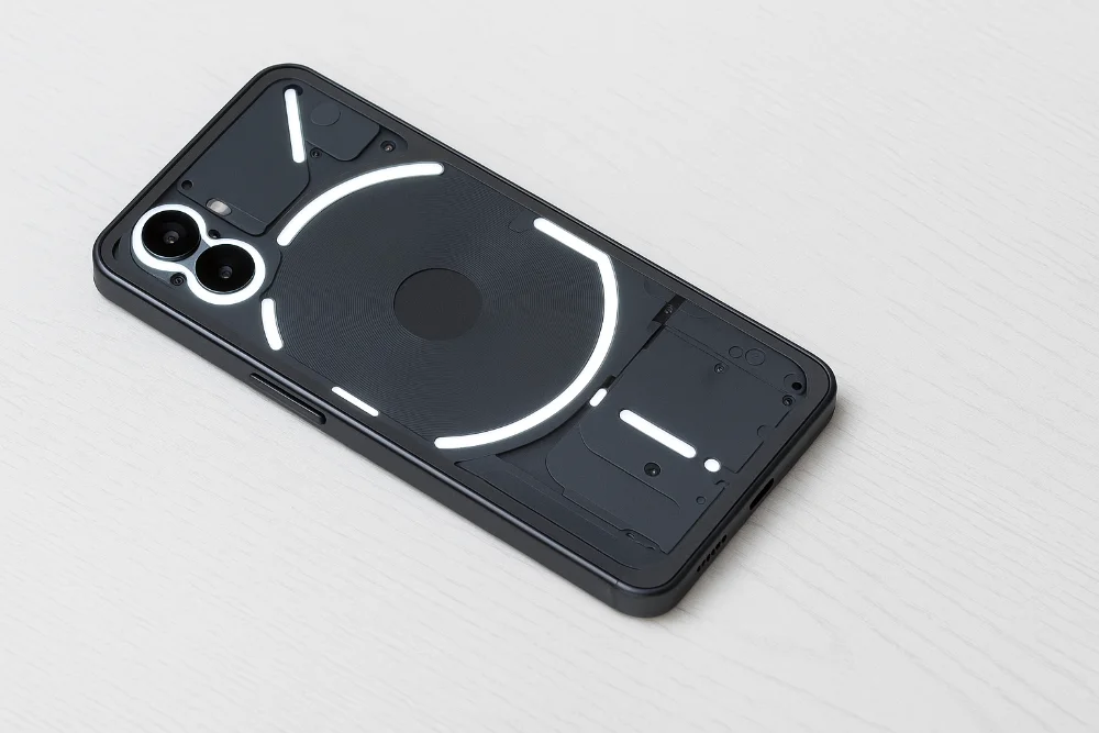 Nothing Phone (3a) — прозрачный корпус и подсветка Glyph в минималистичном дизайне Смартфон Nothing Phone (3a) на белом фоне с прозрачной задней панелью и фирменной подсветкой Glyph, современный минималистичный стиль