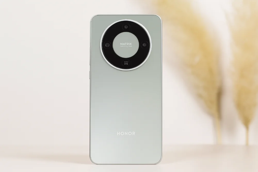 Honor Magic 8 Lite в мятном цвете на светлом фоне 📱 Смартфон Honor Magic 8 Lite в мятном оттенке с круглым модулем камер, размещенный на светлом столе